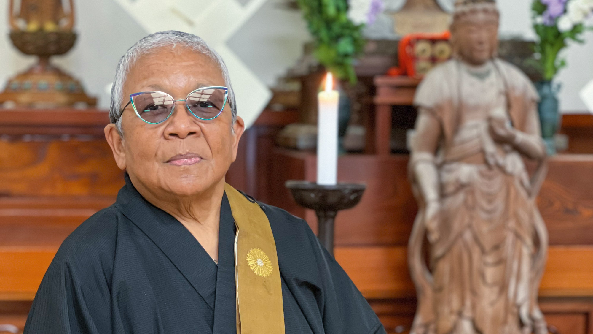 Portrait of Myokei Caine-Barrett by buddhist altar
