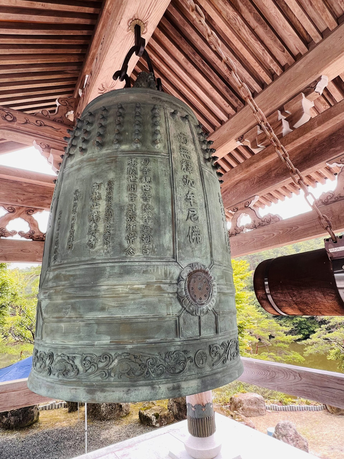 A bell inscribed with Buddhist dedications.