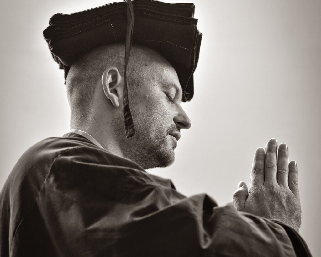 Man in Zen robes with hands in gassho