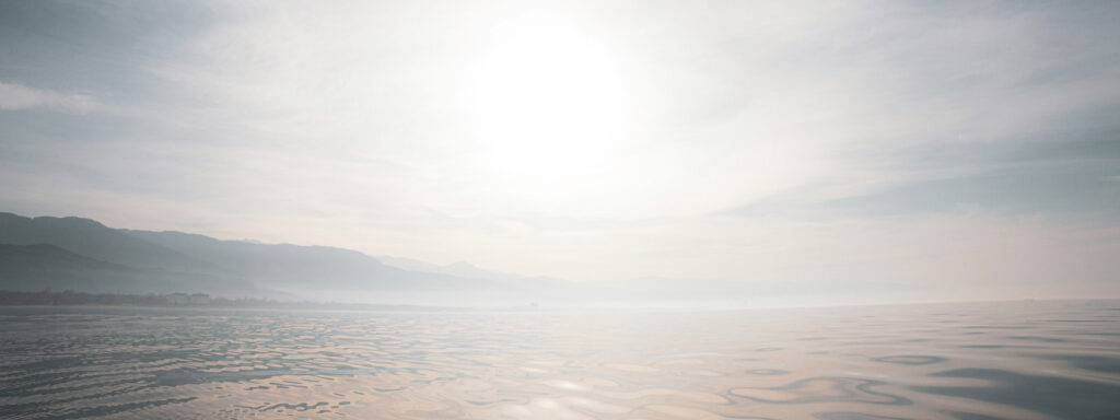 image of light in sky over ocean.