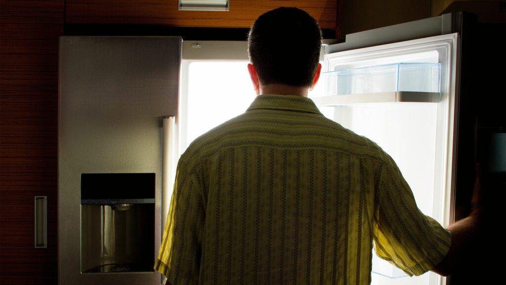 Man looking into fridge