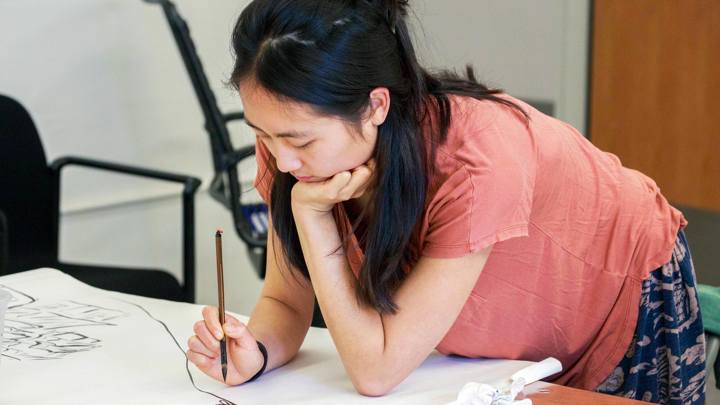 Graduate student Brenda Li painting a visual interpretation of a classical Chinese poem in her classical Chinese language class.