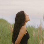 woman standing in grass breathing