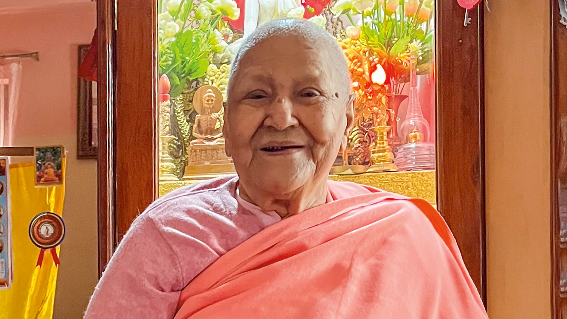 Bhikkhuni Dhammawati Guruma smiles in pink robes