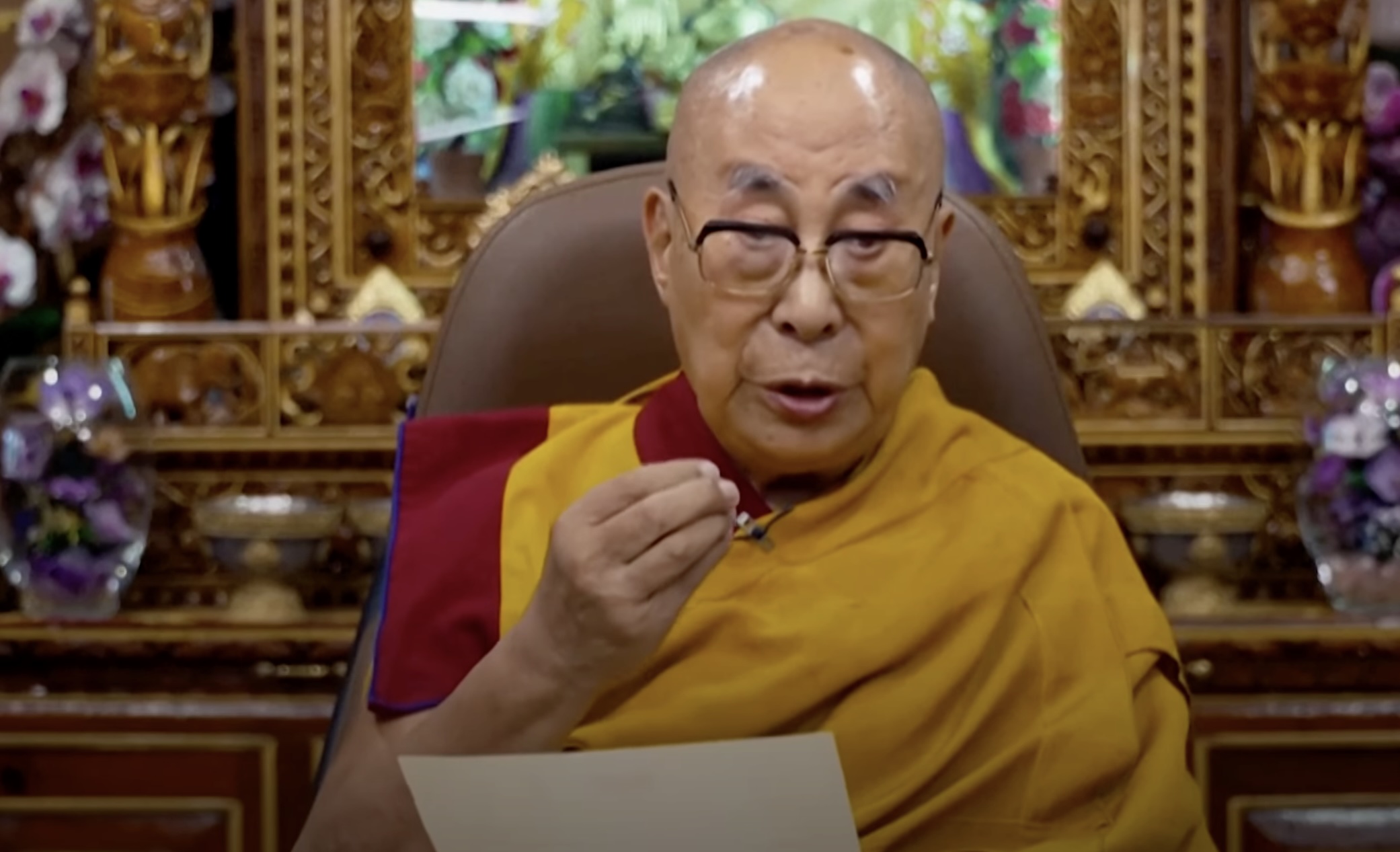 The Dalai Lama is seen giving his new statement to camera.