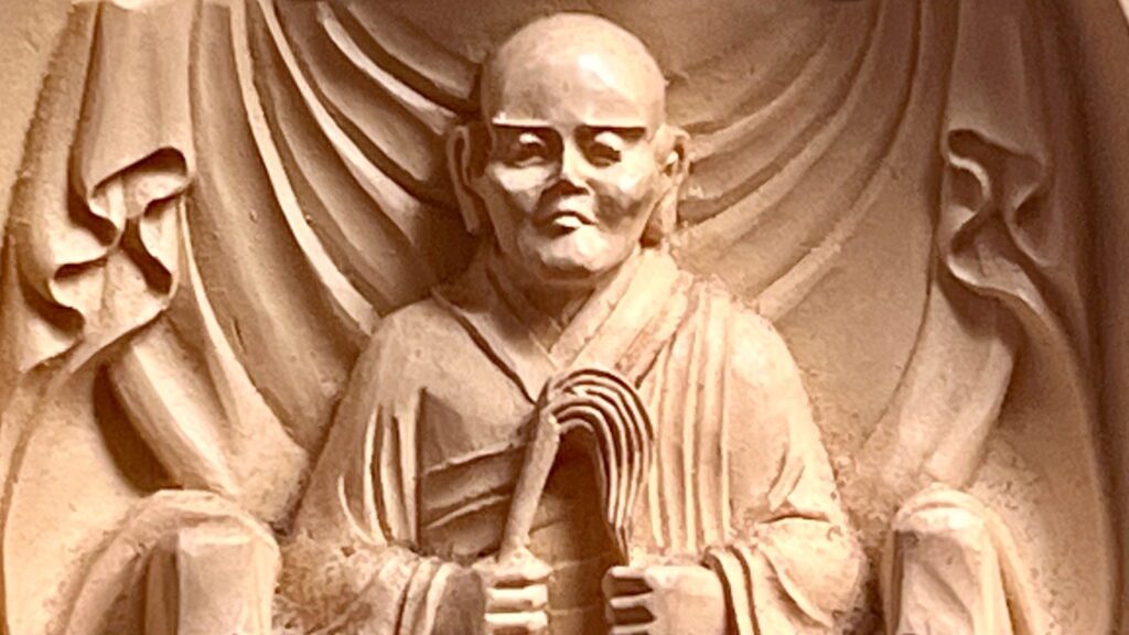 A small statue of Eihei Dogen in seen up close.