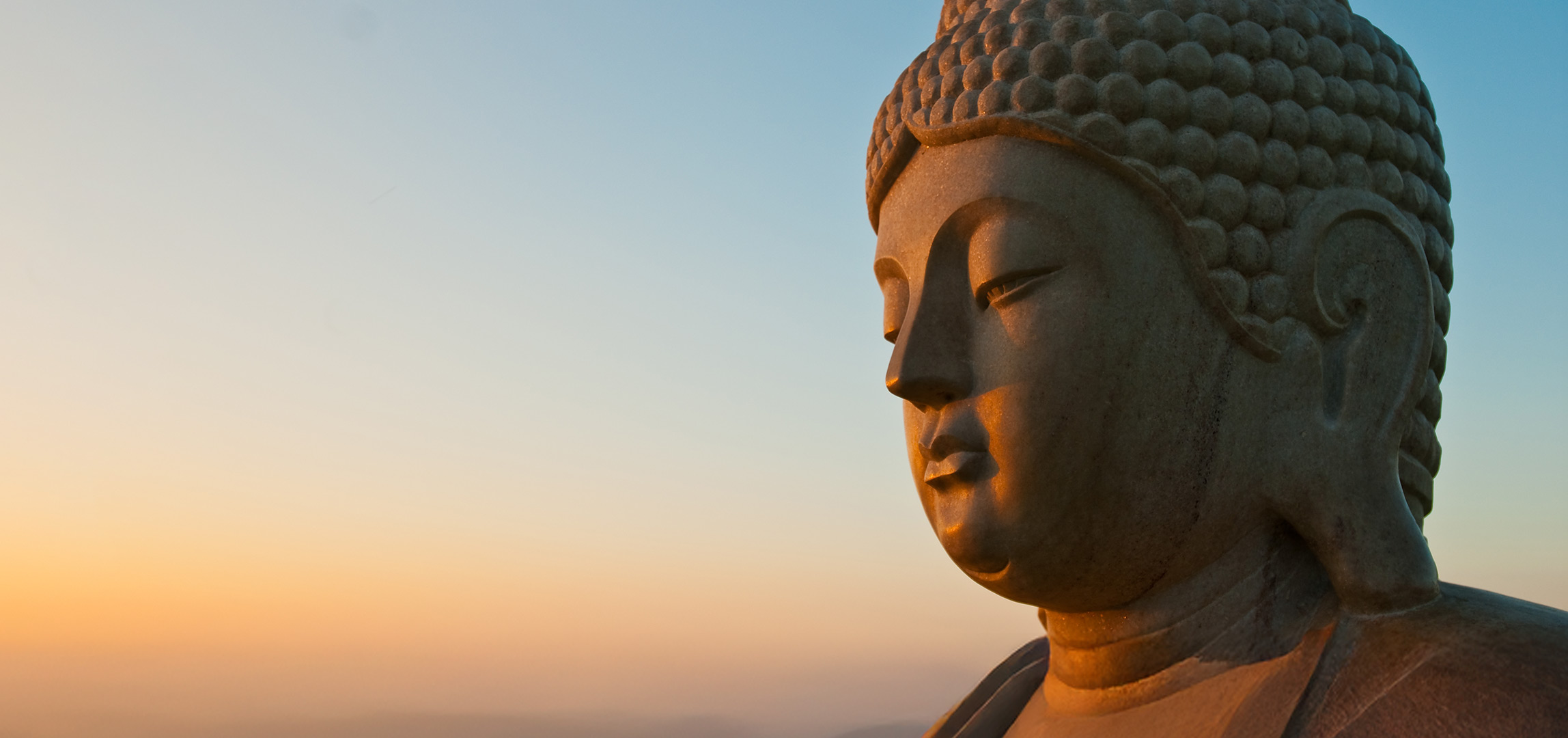 Peaceful Buddha statue against sky