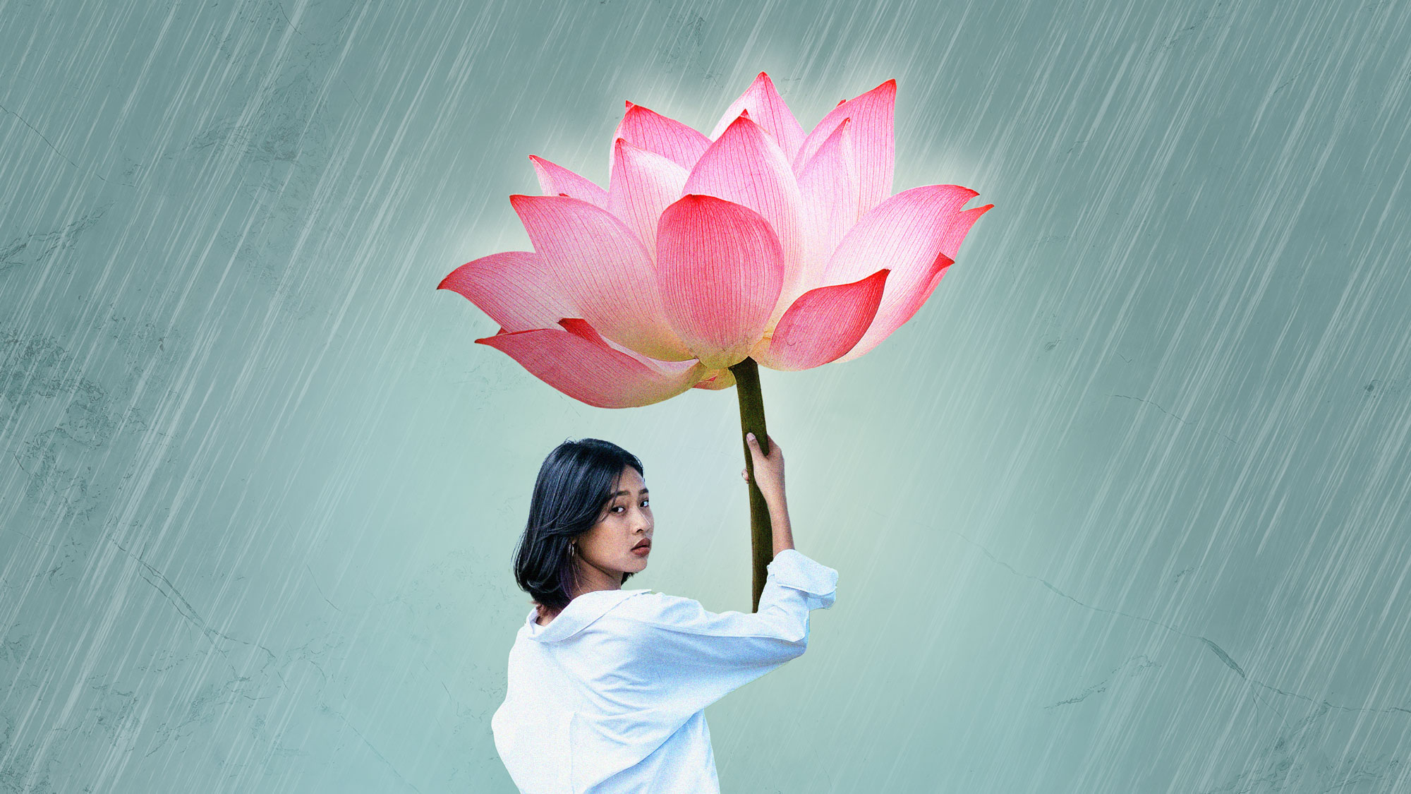 A woman holding a lotus flower as an umbrella.